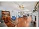 Spacious living area with hardwood floors, fireplace, and open access to the dining room and kitchen at 4020 Mcintosh Rd, Dover, FL 33527
