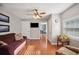 Cozy living room with hardwood floors and lots of natural light from the large window at 4020 Mcintosh Rd, Dover, FL 33527
