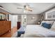 Spacious main bedroom with wood floors, a ceiling fan, and light grey painted walls at 4020 Mcintosh Rd, Dover, FL 33527