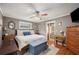 Relaxing main bedroom features a sitting nook, ceiling fan, and ensuite bathroom at 4020 Mcintosh Rd, Dover, FL 33527