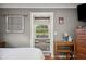 Main bedroom sitting nook offers serene view of backyard, complemented by vintage decor at 4020 Mcintosh Rd, Dover, FL 33527