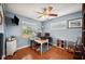 Cozy office space with hardwood floors, natural light from windows, and a ceiling fan at 4020 Mcintosh Rd, Dover, FL 33527