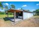Charming outbuilding with a rustic wooden deck and vintage-style decor, creating a unique and inviting space at 4020 Mcintosh Rd, Dover, FL 33527