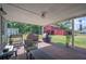 Covered patio with brick flooring featuring outdoor seating and cooking area overlooking backyard at 4020 Mcintosh Rd, Dover, FL 33527