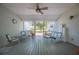 Relaxing porch featuring an overhead fan, open air design, and vintage furniture at 4020 Mcintosh Rd, Dover, FL 33527