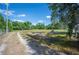 Scenic view of land with mature trees, a tranquil bench, and a meandering dirt path at 4020 Mcintosh Rd, Dover, FL 33527