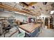 Well-lit workshop with large work table, tools, storage, and ample space for projects at 4020 Mcintosh Rd, Dover, FL 33527