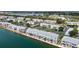 Aerial view of the waterfront condo neighborhood showcases water access, green spaces, and neighborhood parking at 4778 Coquina Key Se Dr # 4778, St Petersburg, FL 33705