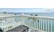 Balcony with seating featuring stunning views of the ocean, sky, and palm trees at 4778 Coquina Key Se Dr # 4778, St Petersburg, FL 33705