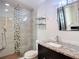 Bathroom features a granite-top vanity and a glass-enclosed shower with unique tiling at 4778 Coquina Key Se Dr # 4778, St Petersburg, FL 33705