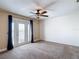 Spacious bedroom with carpet and ceiling fan, and a door leading to a balcony with a water view at 4778 Coquina Key Se Dr # 4778, St Petersburg, FL 33705