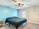 Bedroom features a ceiling fan and a window, complemented by neutral wall tones at 4778 Coquina Key Se Dr # 4778, St Petersburg, FL 33705