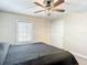 Bedroom with carpeted floors, neutral paint, ceiling fan, and a window allowing natural light at 4778 Coquina Key Se Dr # 4778, St Petersburg, FL 33705