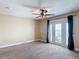 Bedroom with a ceiling fan and a door to a balcony with a view of the ocean at 4778 Coquina Key Se Dr # 4778, St Petersburg, FL 33705