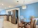 Cozy dining area featuring stainless steel appliances, granite countertops, and wood-style flooring at 4778 Coquina Key Se Dr # 4778, St Petersburg, FL 33705