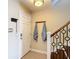 Close-up of the entryway featuring a coat rack, a door with a modern lock, and a staircase at 4778 Coquina Key Se Dr # 4778, St Petersburg, FL 33705