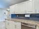 Kitchen featuring granite countertops, stainless steel dishwasher and dark backsplash at 4778 Coquina Key Se Dr # 4778, St Petersburg, FL 33705