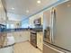 Modern kitchen features stainless steel appliances, granite countertops, and ample cabinet space for storage at 4778 Coquina Key Se Dr # 4778, St Petersburg, FL 33705