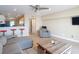 Open-concept living room with tile flooring, comfortable seating, and adjacent kitchen with bar stools at 4778 Coquina Key Se Dr # 4778, St Petersburg, FL 33705