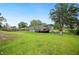 Fenced backyard featuring a well-maintained lawn, a playset, and a deck off the home at 6433 Mangrove Dr, Wesley Chapel, FL 33544