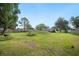 Expansive backyard featuring a large grassy area perfect for outdoor activities and relaxation at 6433 Mangrove Dr, Wesley Chapel, FL 33544