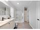 Bathroom featuring updated vanity, toilet, and glass door shower, complemented by wood-look flooring at 6433 Mangrove Dr, Wesley Chapel, FL 33544