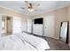 Bright bedroom with neutral walls, ceiling fan, walk-in closet, and a full-length mirror at 6433 Mangrove Dr, Wesley Chapel, FL 33544