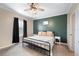 Relaxing bedroom with a black metal bed frame, and soothing color palette at 6433 Mangrove Dr, Wesley Chapel, FL 33544
