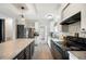 Modern kitchen with stainless steel appliances, white cabinets and large island at 6433 Mangrove Dr, Wesley Chapel, FL 33544