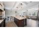 Open-concept kitchen with island adjacent to the living room at 6433 Mangrove Dr, Wesley Chapel, FL 33544