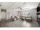Open-concept living room featuring lots of natural light and cozy seating at 6433 Mangrove Dr, Wesley Chapel, FL 33544