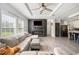 Stylish living room featuring a modern fireplace and large windows at 6433 Mangrove Dr, Wesley Chapel, FL 33544