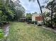 A well-maintained lawn with lush trees behind the property at 135 Wild Palm Dr, Bradenton, FL 34210