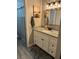 Stylish bathroom featuring a granite countertop vanity, modern fixtures, and a shower with neutral decor at 135 Wild Palm Dr, Bradenton, FL 34210