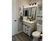 Nicely updated bathroom features a stylish vanity, decorative mirror, and a modern sliding cabinet door at 135 Wild Palm Dr, Bradenton, FL 34210