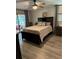 Cozy bedroom featuring a comfortable bed, sliding glass doors to the patio, and neutral decor at 135 Wild Palm Dr, Bradenton, FL 34210
