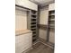 Spacious walk-in closet with custom shelving, drawers, and ample storage, perfect for organization at 135 Wild Palm Dr, Bradenton, FL 34210