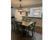 Charming dining area features a wooden table with seating for six under an elegant chandelier at 135 Wild Palm Dr, Bradenton, FL 34210