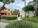Inviting condo exterior with lush landscaping and a charming walkway to the front door at 135 Wild Palm Dr, Bradenton, FL 34210