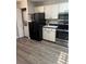 Bright kitchen featuring modern appliances and a stacked washer and dryer at 135 Wild Palm Dr, Bradenton, FL 34210