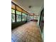 Enclosed lanai area featuring ceramic tiled floor, many windows, and a comfortable sofa at 135 Wild Palm Dr, Bradenton, FL 34210