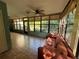 Enclosed lanai area featuring ceramic tiled floor, lots of windows, and a comfortable sofa at 135 Wild Palm Dr, Bradenton, FL 34210