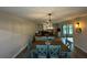Open living area with a dining table, comfortable seating, and natural light from sliding glass doors at 135 Wild Palm Dr, Bradenton, FL 34210