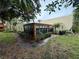 A fenced-in patio extends off of the house with plentiful windows and screens at 135 Wild Palm Dr, Bradenton, FL 34210
