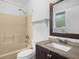 This bathroom features a shower/tub combo, a window, and a vanity with a sink at 3205 N 66Th St, Tampa, FL 33619