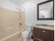 Simple bathroom with a tub/shower combination and a dark wood vanity at 3205 N 66Th St, Tampa, FL 33619