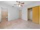 Bedroom features a ceiling fan, closet, and neutral tile flooring at 3205 N 66Th St, Tampa, FL 33619