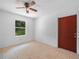 Bright bedroom features tile floors, a ceiling fan, a window and a door at 3205 N 66Th St, Tampa, FL 33619