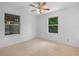 Cozy bedroom featuring natural light from two windows and a ceiling fan at 3205 N 66Th St, Tampa, FL 33619