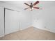 Bedroom featuring neutral tile flooring, a closet with sliding doors, and ample space at 3205 N 66Th St, Tampa, FL 33619